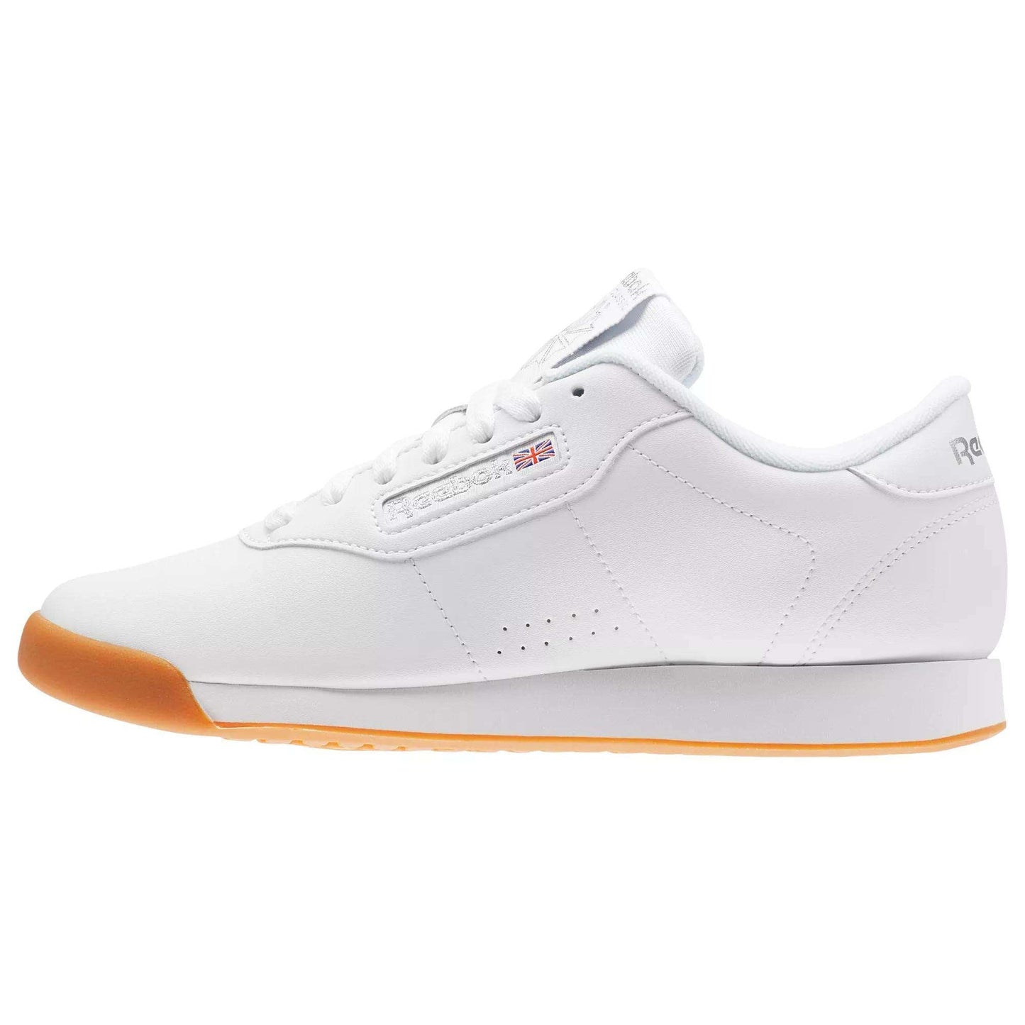The Women’s Princess Shoes by Reebok are classic white sneakers featuring a cushioned footbed, gum sole, low-top design, perforated sides, and signature Reebok branding.
