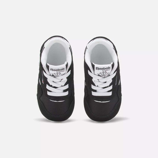 A pair of Reebok Kids' Classic Nylon Shoes for toddlers is shown from above on a white background. The shoes feature a black and white suede and nylon upper, white laces, and the Reebok logo on the tongue.