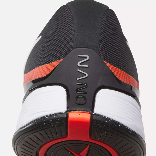 Close-up of the heel on the black Reebok Nano X4 Training Shoes, featuring red and white accents. The word NOVA is embossed on a black heel support, and the outsole displays a circular tread pattern.