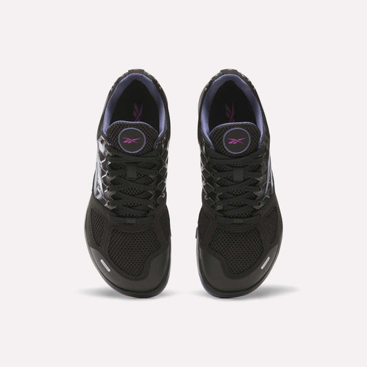 A pair of Women's Nano 2.0 Training Shoes by Reebok in black with black laces, purple lining, and a purple logo on the tongue, designed for functional fitness and shown from above on a white background.