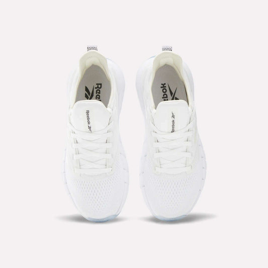 A pair of Women's Nano Gym Training Shoes by Reebok in white, shown from above with visible laces, mesh upper, and Reebok branding on the tongue and insole.