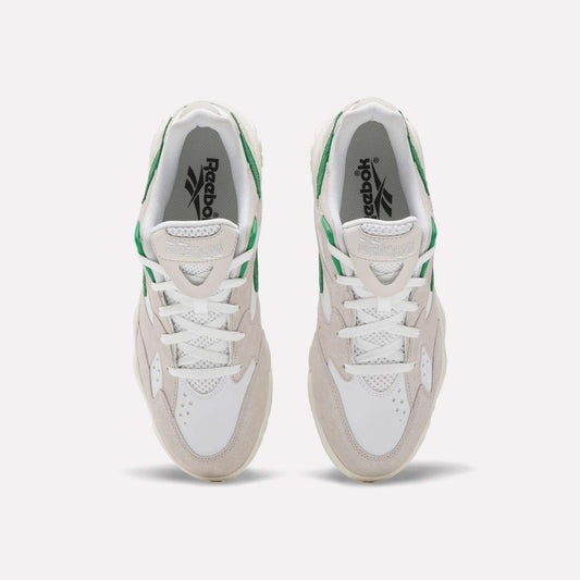 A top view of Reebok Preseason 94 Low Retro Basketball Shoes in white with beige suede and green accents, inspired by '90s athletic styles, displayed on a plain light background.