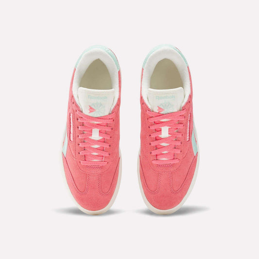 Top view of a pair of Reebok Campio Extra Women's Shoes in pink with white platform midsoles, pale blue accents, and white interior lining, displayed side by side on a plain light background.