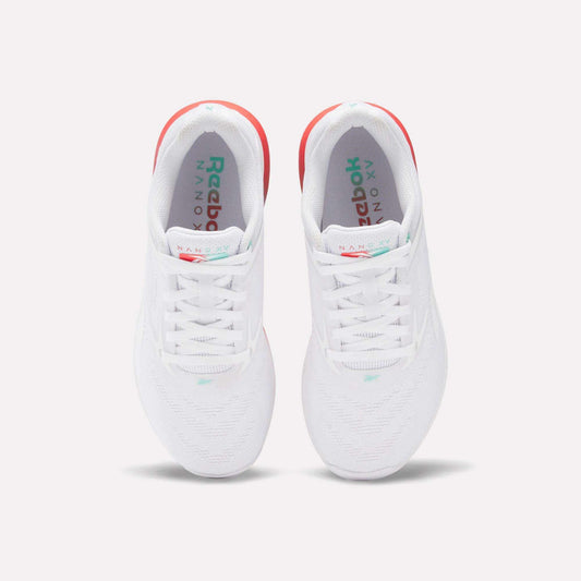 A pair of Reebok Women's Nano X5 Training Shoes in white, seen from above, with white laces, subtle teal accents, and a hint of red on the heels for comfort.