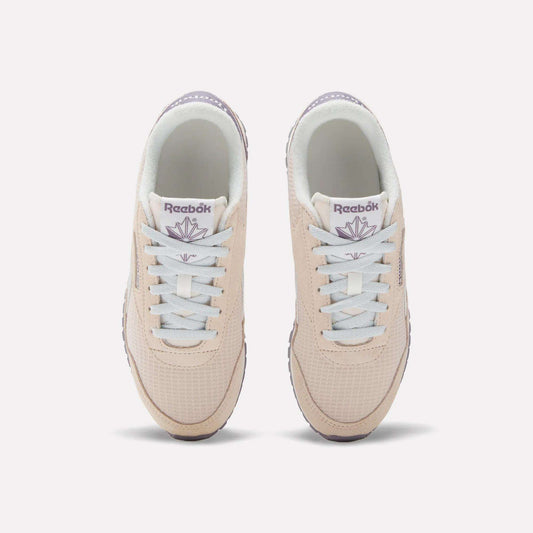 The Women's Classic AZ Shoes by Reebok are beige with white laces and light purple branding, shown from above on a white background—ideal for fans of 70s-style sneakers.