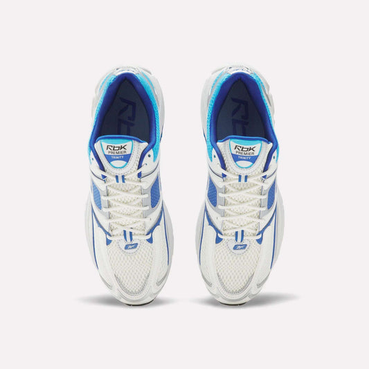 Top view of Reebok Premier Trinity Shoes—white mesh running shoes with blue accents and white laces—side by side on a plain white background, showcasing retro-inspired tech style.