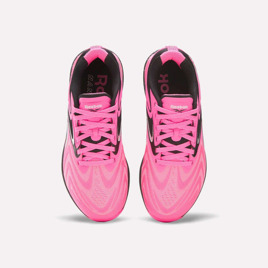 A pair of Women's Nano X5 Edge Training Shoes by Reebok in bright pink with black accents, pink laces, and a bold wavy pattern—ideal for your next HIIT session.