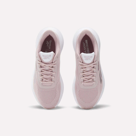 A pair of Women's Energen Run 4 Running Shoes by Reebok in light pink with white soles, viewed from above on a plain white background. These lightweight shoes have a breathable mesh upper, laces, and Reebok branding on the tongue and insole.