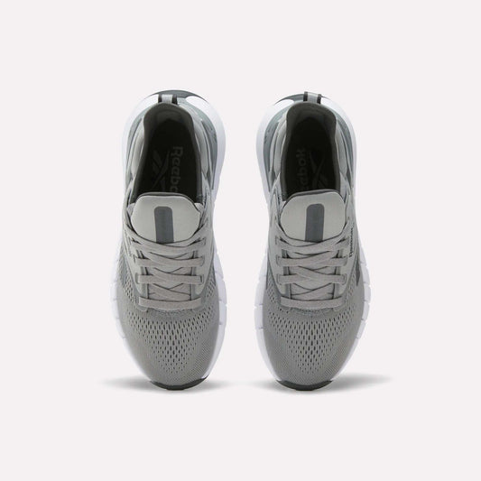 A pair of Women's Nano Gym Training Shoes by Reebok in gray, shown from above with mesh uppers, gray laces, and white soles on a plain white background.
