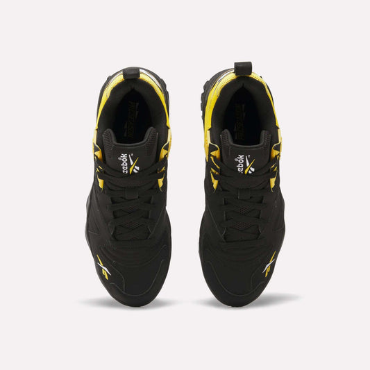 Top view of a pair of black Reebok Brutus Low Shoes with yellow accents and white Reebok logos on the tongues and sides, displayed side by side on a plain white background for street-ready style.