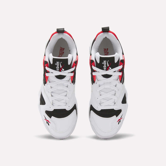 A pair of Brutus Low Shoes by Reebok seen from above, featuring a white base with black and red accents, white laces, and Reebok logos on the tongue and side—ideal for street-ready style.