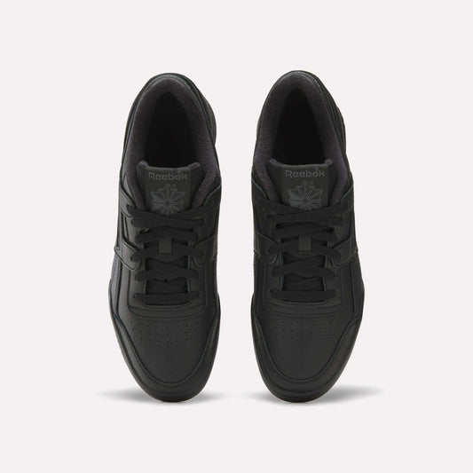 A top view of Reebok Workout Plus Shoes in black reveals laces, perforated toe boxes, and the Reebok logo on the tongues, showcasing classic '80s fitness style against a plain white background.