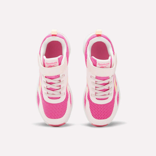 A pair of Reebok Energen Running Shoes for little kids in pink and white, viewed from above, showcasing breathable mesh uppers, laces, and a Velcro strap on each shoe, set against a light background.