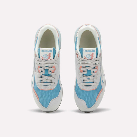 The Reebok Women's Classic Nylon 89 Shoes, seen from above, feature light blue mesh, white overlays, light gray laces, pink accents, retro style details, and the Reebok logo on the tongue.