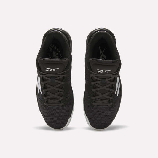 Top view of a pair of Reebok Engine LT Shoes in black with white logos and accents, featuring mesh uppers and black laces, placed side by side on a white background.