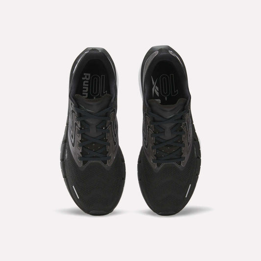 Top view of Reebok Men's FloatZig Tread Running Shoes in black with cushioned midsoles and grey accents, side by side on a white background. Insoles display “Run” and “XOL” in white—ideal for treadmill sessions.