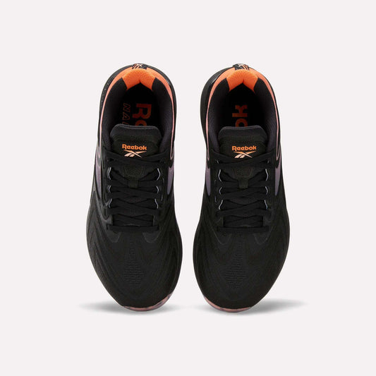 Top view of Women's Nano X5 Edge Training Shoes by Reebok in black with orange heel and inner accents, Reebok logo on tongue and insole. Shoes shown side by side on a white background.