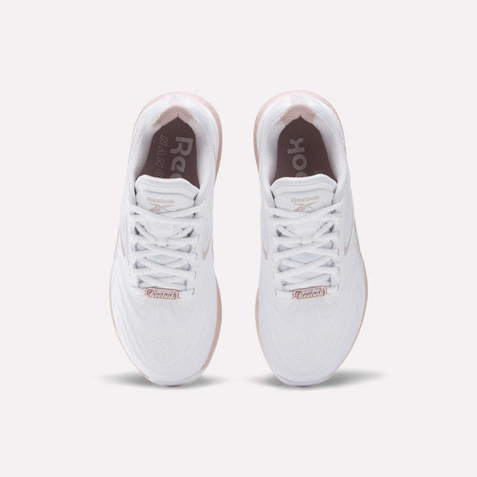 The Reebok Women's Nano X5 Edge Training Shoes feature a white upper, white laces, and a light pink sole. The Reebok logo appears on the insoles and tongue, combining style and performance—ideal for HIIT workouts.