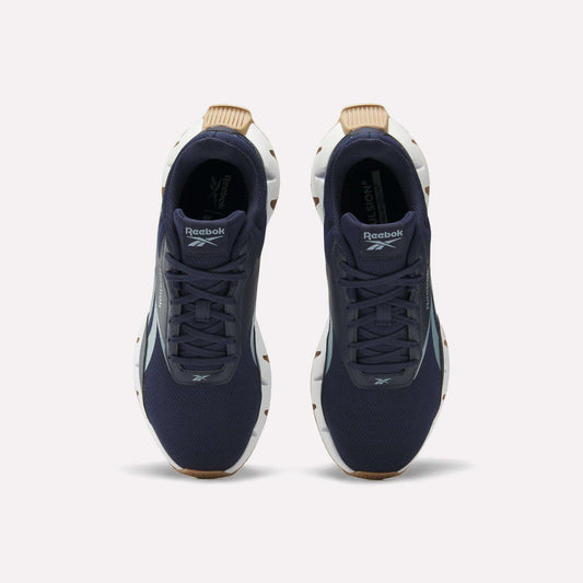 A pair of Reebok Zig Dynamica STR Shoes in dark blue with a breathable mesh upper, white soles, and brown accents, viewed from above on a plain white background.