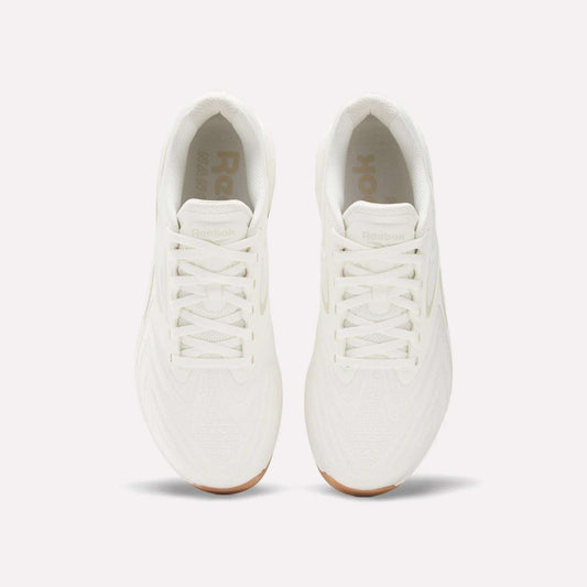 Top view of Reebok Nano X5 Edge Training Shoes in all-white with white laces and gum soles, placed side by side on a plain light background, designed for peak performance.