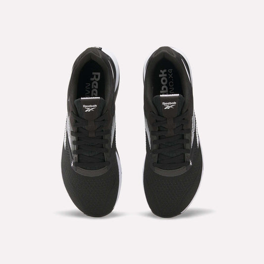 Top view of a pair of black Reebok Nano X4 Training Shoes with white soles and visible Reebok logos on the tongue and inner sole, displayed side by side on a white background.