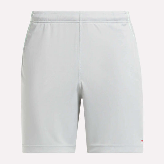 Front view of plain light gray Reebok Men's Train Blocked Knit Shorts featuring an elastic waistband and a small red logo on the lower left leg, ideal for workout enthusiasts.