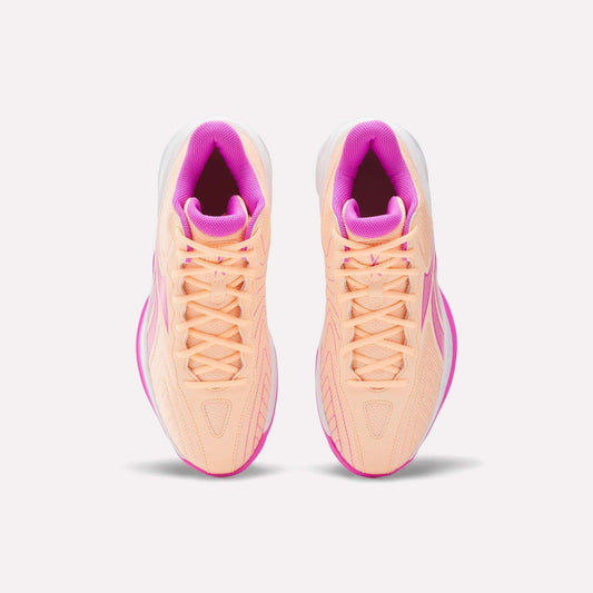 Top view of Reebok Press Basketball Shoes in peach with pink accents and white soles. Featuring EVA cushioning for comfort, these stylish and responsive shoes are side by side on a plain white background.