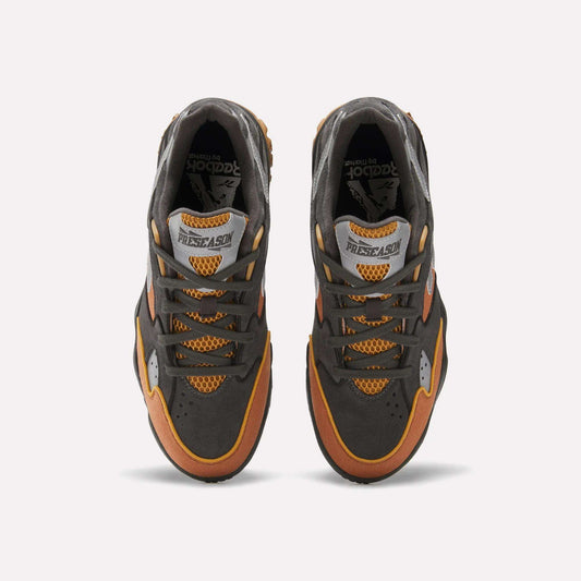 Top view of Reebok x MARKET Preseason 94 Low Shoes in dark gray, orange, and yellow, featuring mesh details and “PRESEASON” on the tongue, shown against a plain white background.