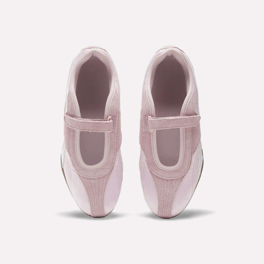 A pair of Women's Ultra Lo Mary Jane Shoes by Reebok in light pink with velcro straps, styled as low-profile runners, shown from above on a plain white background.