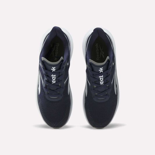Top view of a pair of Reebok Men's Viva Speed Shoes in navy blue, featuring breathable material, white soles, and white Reebok logos on the tongues, placed side by side on a plain white background.
