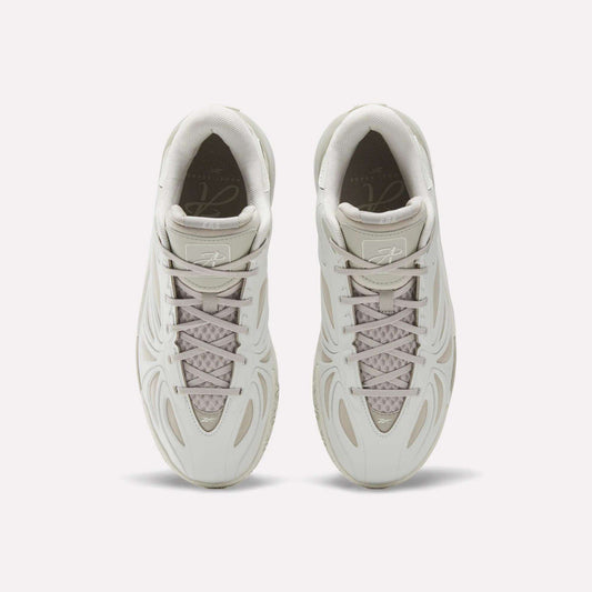 Top view of the Reebok Angel Reese 1 Basketball Shoes in light beige, featuring wavy line designs, mesh tongue detail, and neatly tied laces—these performance sneakers with Energy Return System are displayed side by side on a white background.