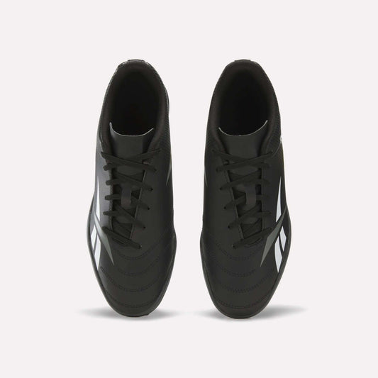 Top view of a pair of Reebok Strike Turf Soccer Shoes in black with white accents and black laces, placed side by side on a plain white background—perfect for soccer practice.