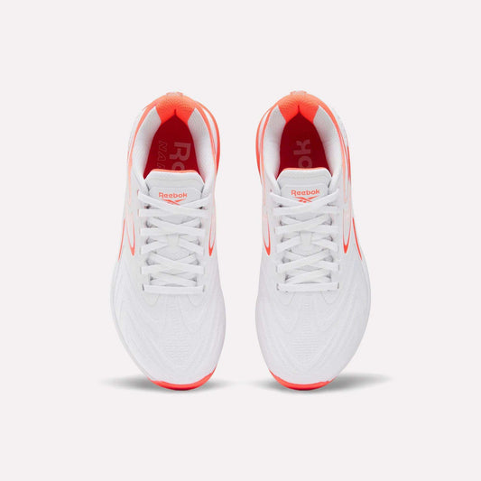 Top view of Reebok Women's Nano X5 Edge Training Shoes in white with red accents on the sole, inner lining, and logo, placed side by side on a plain white background.