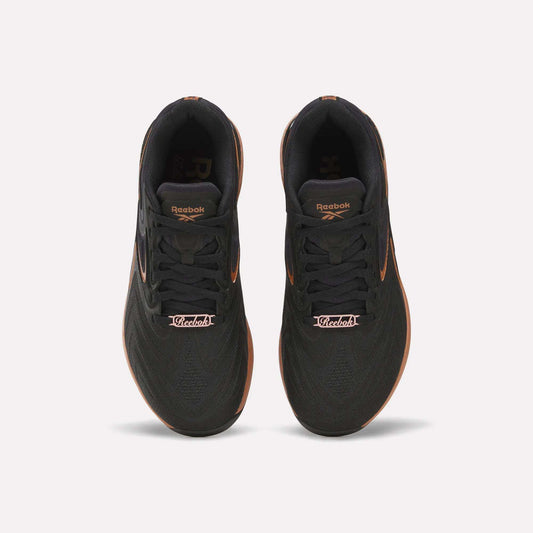 Top view of Reebok Women's Nano X5 Edge Training Shoes in black with orange accents and “Victoria” on the laces—ideal for your next HIIT class.