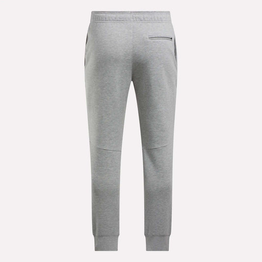 Back view of Reebok Men's Motion Joggers in light gray featuring a slim fit, elastic waistband, two side pockets, a zippered back pocket, and ribbed ankle cuffs.