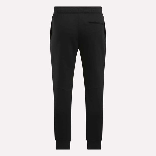 The Reebok Men's Motion Joggers in black slim fit are shown from the back, featuring an elastic waistband, side pockets, a single right back pocket, and tapered legs with ankle cuffs.