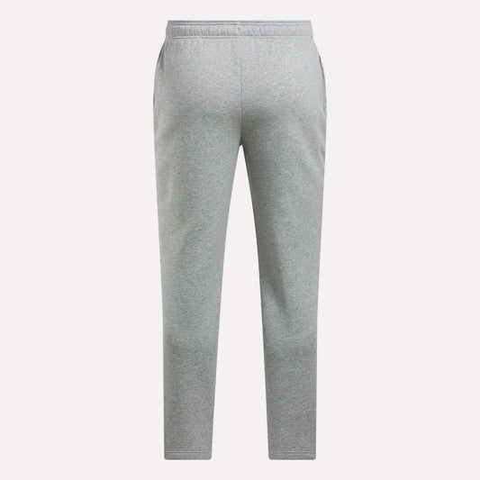 The Reebok Men's Patent Pants feature a plain light gray design with an adjustable waistband and straight legs, displayed against a white background.