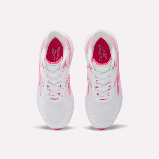 A pair of Women's Viva Speed Shoes by Reebok in white with pink accents, shown from above on a white background. These breathable shoes feature white laces, a cushioned midsole for all-day comfort, and a pink Reebok logo on the insoles.
