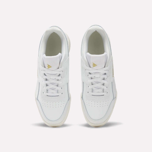 A pair of Reebok Workout Plus Shoes for big kids with laces, seen from above on a light background. These sporty white sneakers have perforated toe boxes and gold triangle logos on the tongues—ideal for juniors who want style and comfort.
