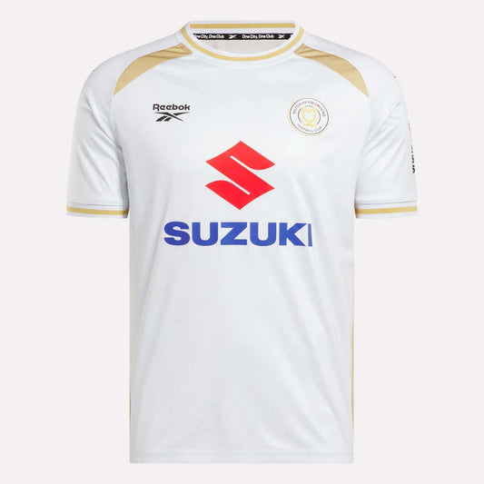 The Men's MK Dons Home Jersey by Reebok is a white football shirt with gold trim, a bold red Suzuki logo on the front, and a circular team crest on the left chest—an iconic piece for Milton Keynes fans.