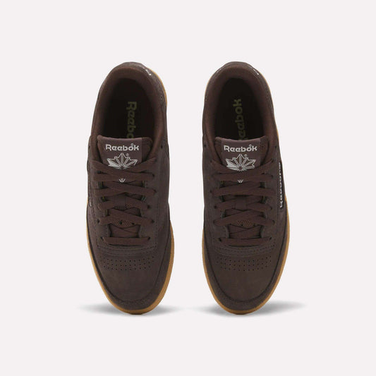 Top view of Women's Club C 85 Shoes by Reebok in dark brown leather with gum soles, white Reebok logos on the tongues, and black laces, shown against a plain light background.