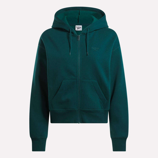 The Reebok Women's Cropped Full-Zip Hoodie in dark green features a cozy knit fabric, hood, front zipper, roomy pockets, and a small embroidered logo on the left chest, shown against a plain white background.