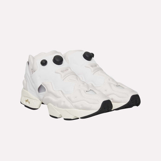 A pair of Reebok Instapump Sliver Shoes in white, featuring chunky soles, black outsoles, and distinctive black pump buttons with InstaPump technology—displayed against a plain light blue background.