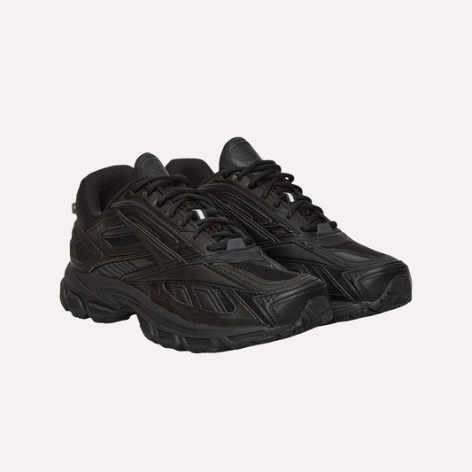 A pair of Reebok Premier Road Ultra black running sneakers with mesh and synthetic uppers, textured soles, dual-density midsoles, and black laces, positioned side by side facing slightly to the right.
