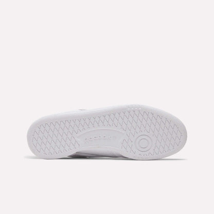 The image shows the sole of the Women's Club C 85 Shoes by Reebok, with a herringbone tread, a circular toe design, and an embossed Reebok logo—ideal for those seeking stylish women's footwear.
