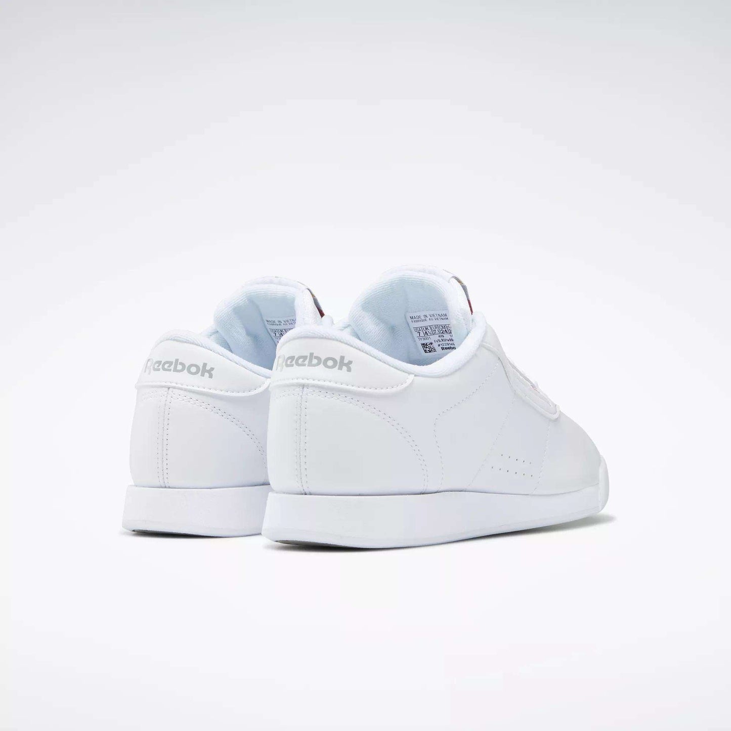 The Women's Princess Shoes by Reebok are shown facing away on a plain white background, featuring the Reebok logo on the heel and a clean, classic design.