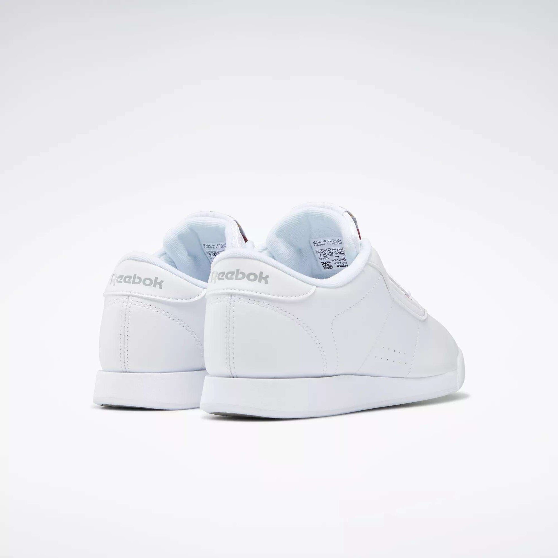 The Women's Princess Shoes by Reebok are shown facing away on a plain white background, featuring the Reebok logo on the heel and a clean, classic design.