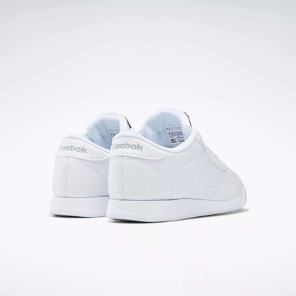 The Women's Princess Shoes by Reebok are shown facing away on a plain white background, featuring the Reebok logo on the heel and a clean, classic design.