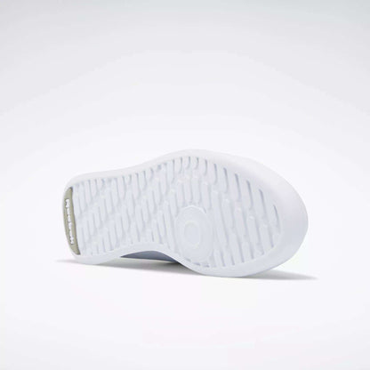The image shows the white rubber outsole of Reebok Women's Princess Shoes, featuring a textured grip pattern and the Reebok logo embossed near the heel against a plain, light background.