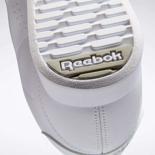 Close-up of the white sole on Reebok Women's Princess Shoes, highlighting the textured tread and gray-beige embossed Reebok logo near the heel—a classic heritage detail from this iconic brand.